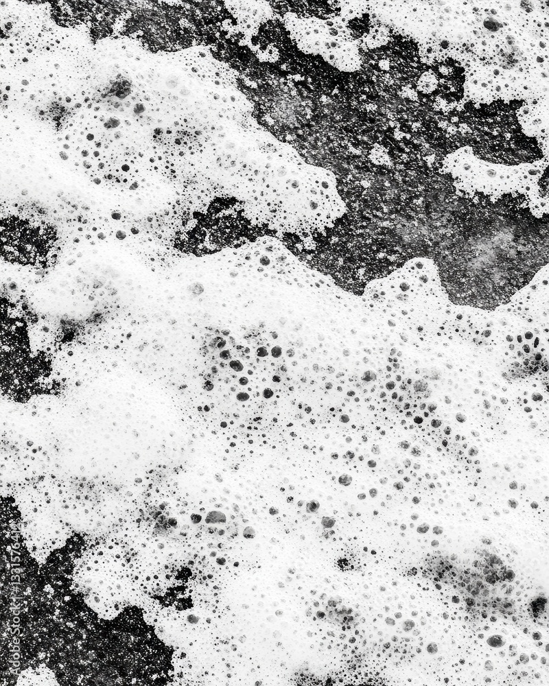 Poster a striking close-up of a black and white photograph capturing the intricate details of a crashing wa