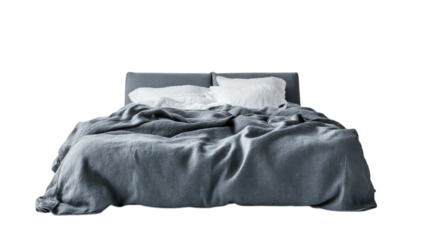 Cozy gray bed with rumpled blanket and fluffy pillows in a minimalist bedroom setting