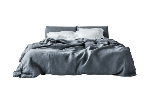 Cozy gray bed with rumpled blanket and fluffy pillows in a minimalist bedroom setting