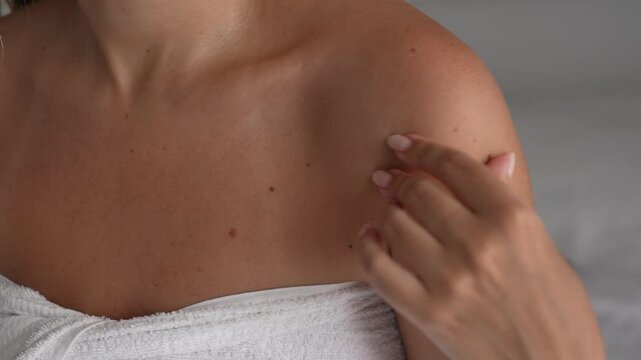 Close-up of a young woman showing her tanned chest with a visible bikini tan line. The focus is on sun-kissed skin, summer vibes, and the contrast left by sun exposure
