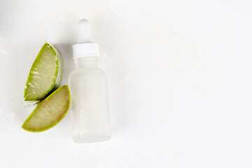 A well-balanced visual with aloe vera pieces and a skincare serum bottle, representing organic and natural beauty care.