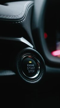 Vertical video. A woman starting the car with a button. Modern technology, comfort, and innovation in vehicles, providing ease of use and control.
