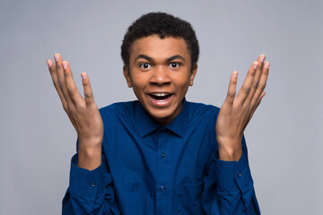 Distraught African American teenager makes helpless gesture.