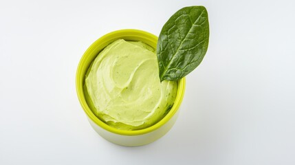 Creamy Green Avocado Dip with Fresh Spinach Leaf on White Background