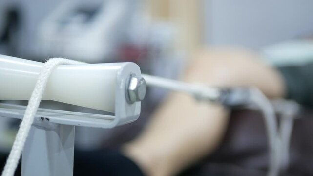 pov with selective focusing to Physiotherapy technique Physiotherapist treatment of woman pelvic traction method machine stretch with rope treatment