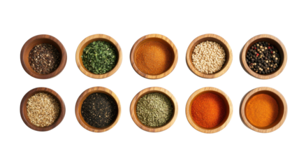Variety of spices and herbs displayed in wooden bowls for culinary use at a kitchen countertop
