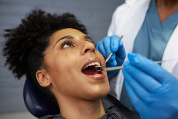 Female Patient Receiving Professional Dental Examination in Modern Clinic by Healthcare Expert