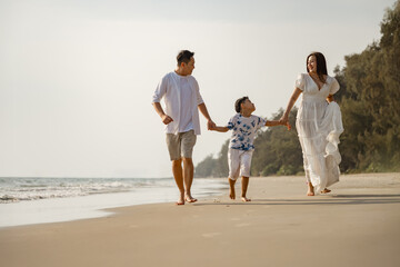 Asian family beach vacation. Children parent relax together. People lifestyle.