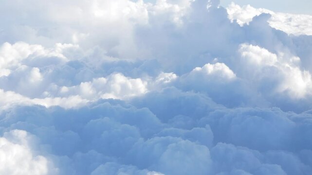 blue sky with white fluffy clouds from airplane flight fly over the clouds in a sunny day with cloud moving in summer, summer cloudscape background