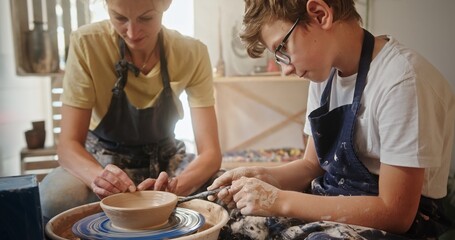 Participating in a Fun and Engaging Pottery Session with Both Adult and Child Together