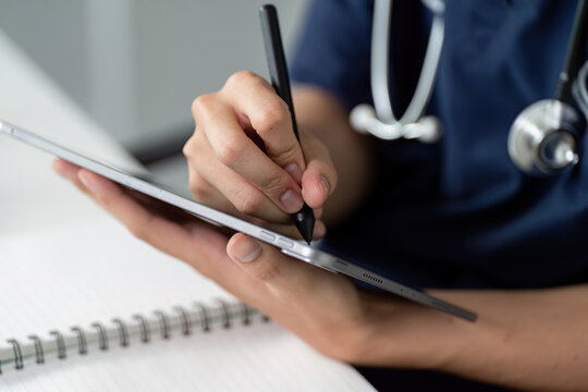 Medical Technology and Student Learning. A medical student taking notes and engaging with digital tools while studying healthcare.