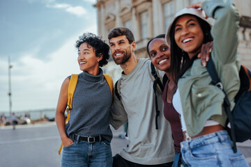Happy tourists visiting european city enjoying summer vacation together