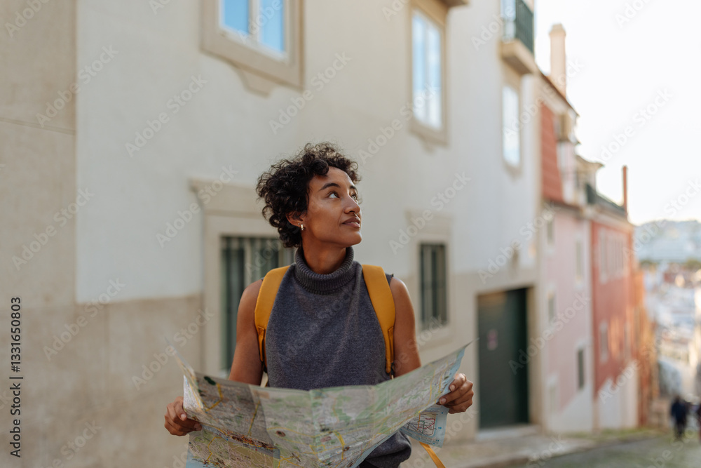 Wall mural tourist exploring lisbon using a map and looking around