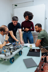 Robotics engineers collaborating on a project in modern office