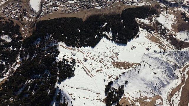 Erosion gully above Sedrun in the Swiss Alps. Flyover in winter towards Piz Medel, part 1 of 2