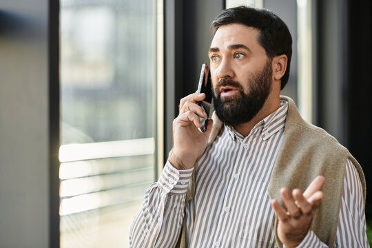 Elderly man engages in thoughtful conversation while standing near a large window indoors