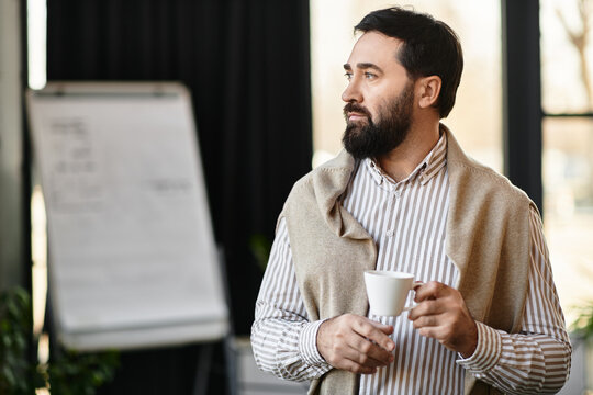 Elderly handsome man enjoying a warm beverage while reflecting in a sunlit space
