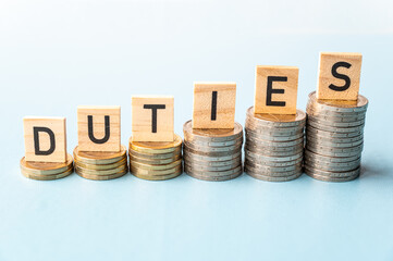 Stacks of coins of increasing height and wooden tiles that spell out the word duties. Consequences...