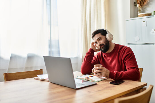 Elderly handsome man enjoying a quiet moment of reflection at home while working on his laptop