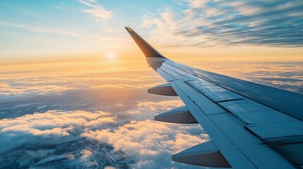 Obraz premium An aircraft wing soaring high above the beautiful clouds and sky