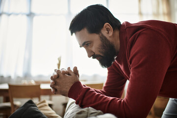 Elderly man exploring nostalgic moments while pondering life in a cozy living room