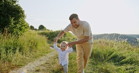 A Joyful Father and His Child Walking Together in Nature, Sharing Moments of Happiness and Laughter