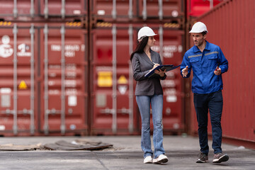 Industrial engineer standing at shipping container yard inspecting cargo delivering loading as...