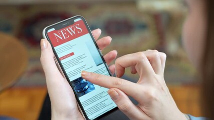 woman reading newspaper on smart phone