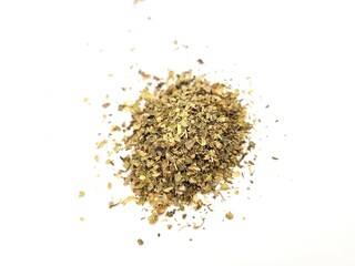 Very aromatic pile of basil leaves on a bright background.
