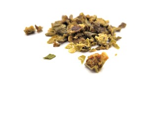 Dried pieces of green paprika on a white background.