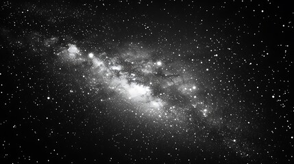 Black and white photograph of a vast star-filled night sky with a dense Milky Way galaxy band.