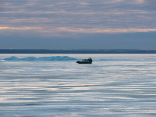 An amphibious hovercraft rushes across the ice of the Gulf of Finland, Russia