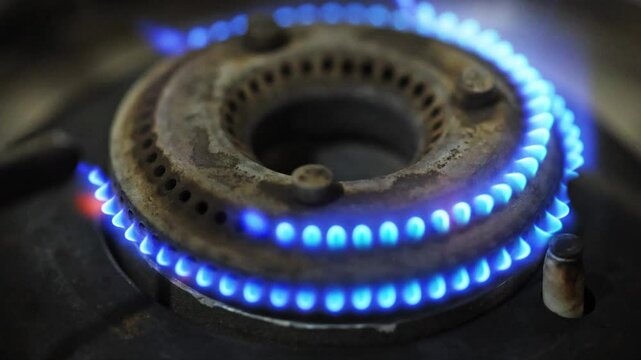 Slo motion Ignition of a blue flame of gas stove, Close-up 4K video