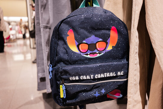 Creative Stich backpack with colorful design displayed in trendy retail store setting