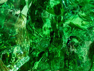 surface of a broken piece of green glass boulder, abstract background 