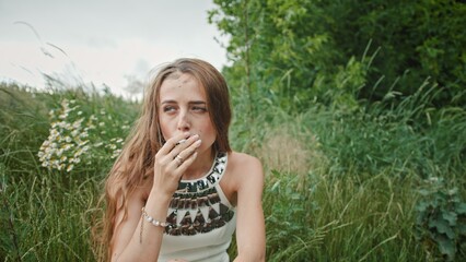 Fototapeta premium A Young Woman in Nature Cherishing a Beautiful Moment of Deep Reflection and Peacefulness