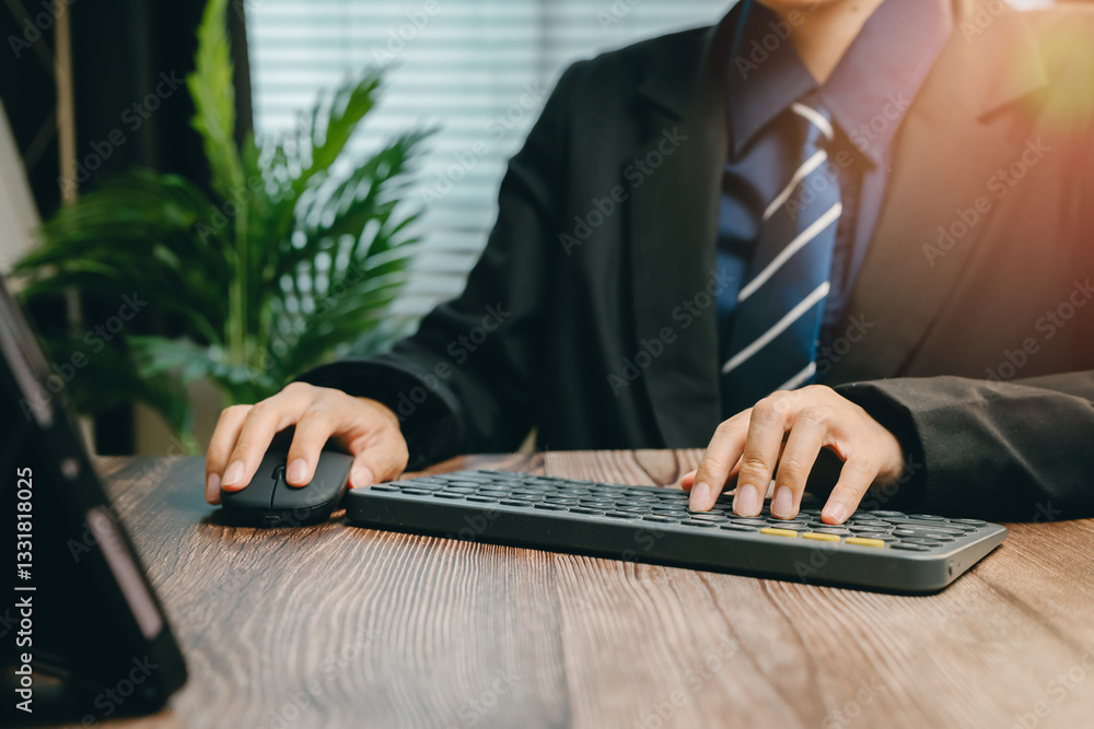 Poster professional man working on computer at desk with keyboard and mouse in modern office setting, busin