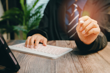 Professional Businessman at Desk Using Keyboard with Touchscreen Stylus in Modern Office...