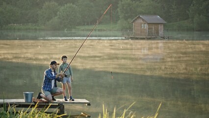 Fishing Time Enjoying a Wonderful Father and Son Bonding Experience by the Beautiful Lake