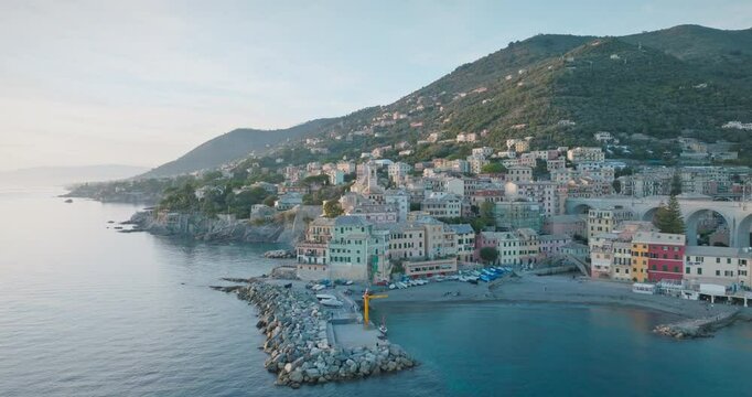 Drone shot of Bogliasco on the Ligurian coast of Italy. Colourful houses, green hills and deep blue sea offer a unique view. The peaceful atmosphere of the Mediterranean can be felt in this seaside to