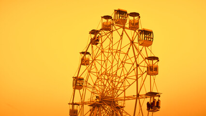 Vintage Ferris Wheel Against Golden Sunset Sky