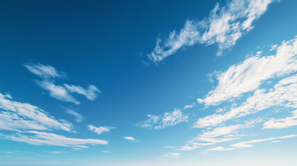 Vast blue skies with soft clouds, a tranquil and open panorama. A serene moment of calm and boundless freedom.