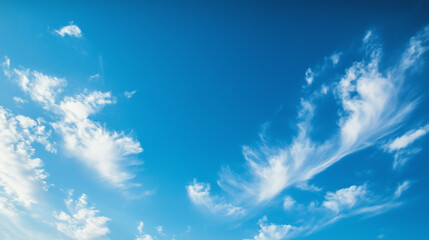 Vast blue skies with soft clouds, a tranquil and open panorama. A serene moment of calm and boundless freedom.