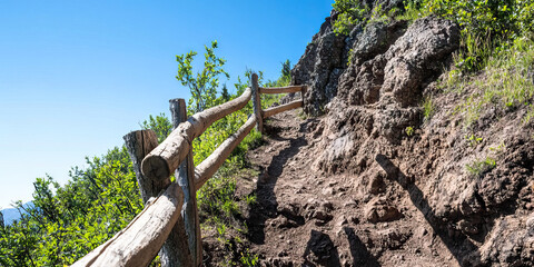 Wooden Fence and Dirt Trail on Rocky Hillside