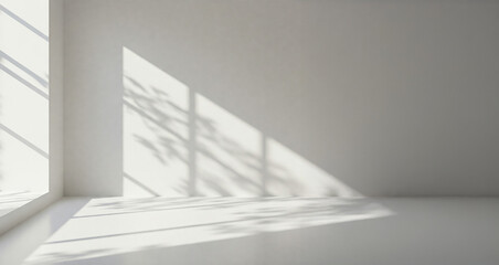 Obraz premium Background texture of a bright, empty white clean room with sunlight streaming through a window, creating geometric shadow patterns on the wall and floor. Blank copy space for interior design