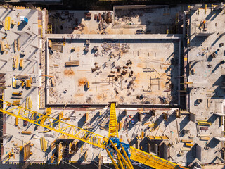 Construction site showcases vibrant materials and equipment under bright sunlight in an urban area....