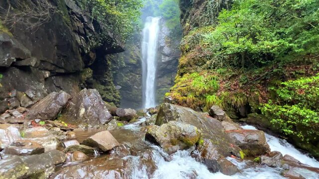 Holy waterfall of Abkhazia on a cloudy winter day in the mountains of the Caucasus. Mountain cascade waterfall. Eastern Abkhazia. Not far from the town of Tkvarcheli. Akarmara district.