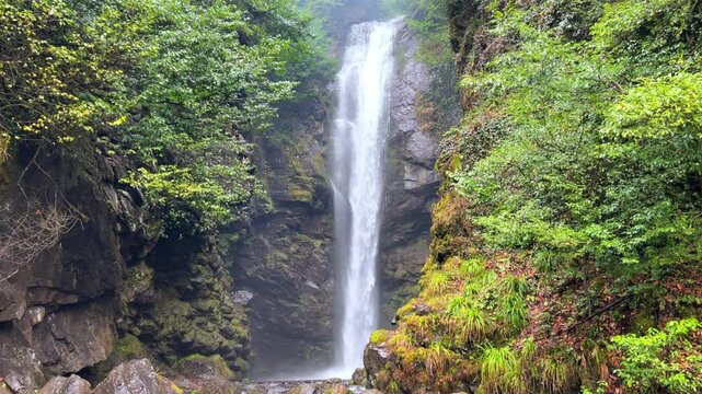 Holy waterfall of Abkhazia on a cloudy winter day in the mountains of the Caucasus. Mountain cascade waterfall. Eastern Abkhazia. Not far from the town of Tkvarcheli. Akarmara district.
