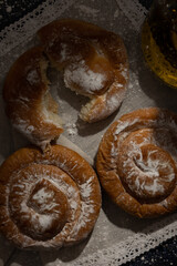 Top view of freshly baked Mallorcan ensaimada on a rustic background. Dark food. Typical Mallorcan food from Spain