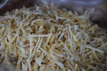 Aloo Lachha, a popular Indian snack made from thinly sliced and fried potatoes which is known for its crispy texture and savory taste, often seasoned with spices